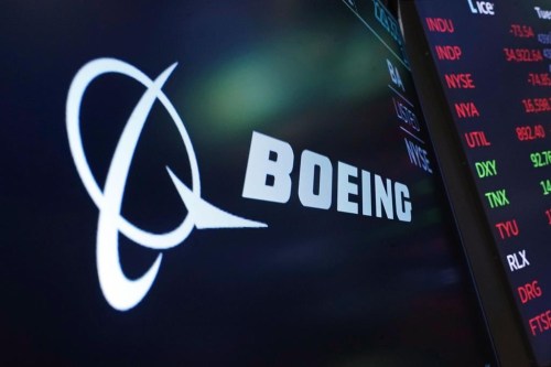 The logo for Boeing appears on a screen above a trading post on the floor of the New York Stock Exchange, July 13, 2021. Boeing Co. is expanding its sizeable footprint in Canada, becoming the anchor tenant of a new innovation zone in the Montreal area. THE CANADIAN PRESS/AP/Richard Drew