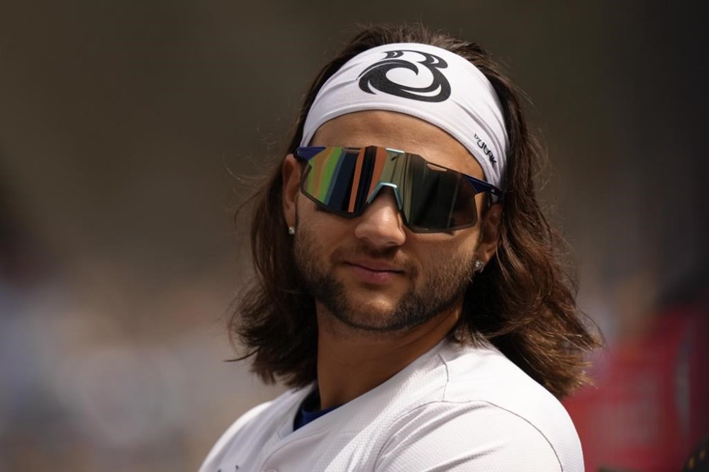 Toronto Blue Jays shortstop Bo Bichette stands in the dugout prior to American League baseball action against the Tampa Bay Rays in Toronto on Saturday, May 18, 2024. A Toronto woman who got hit in the face by a scorching foul boul off the bat of the Blue Jays shortstop is about to receive 110 baseball cards with her photo on them. THE CANADIAN PRESS/Chris Young