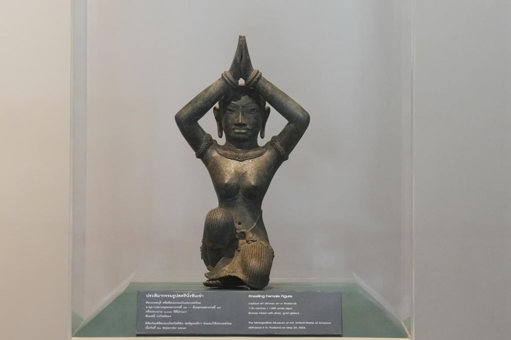 The ancient bronze kneeling woman sculpture is displayed during a repatriation ceremony at National Museum in Bangkok, Thailand, Tuesday, May 21, 2024. Thailand's National Museum hosted a welcome-home ceremony for two ancient statues that were illegally trafficked from Thailand by a British collector of antiquities and were returned from the collection of New York’s Metropolitan Museum of Art. The objects, a tall bronze figure called the “Standing Shiva” or the “Golden Boy” and a smaller sculpture called “Kneeling Female,