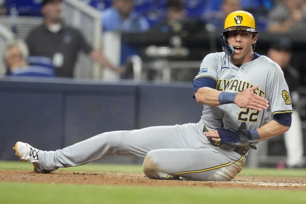 Milwaukee Brewers' Christian Yelich (22) reacts after he was tagged out at the plate during the third inning of a baseball game against the Miami Marlins, Tuesday, May 21, 2024, in Miami. (AP Photo/Lynne Sladky)