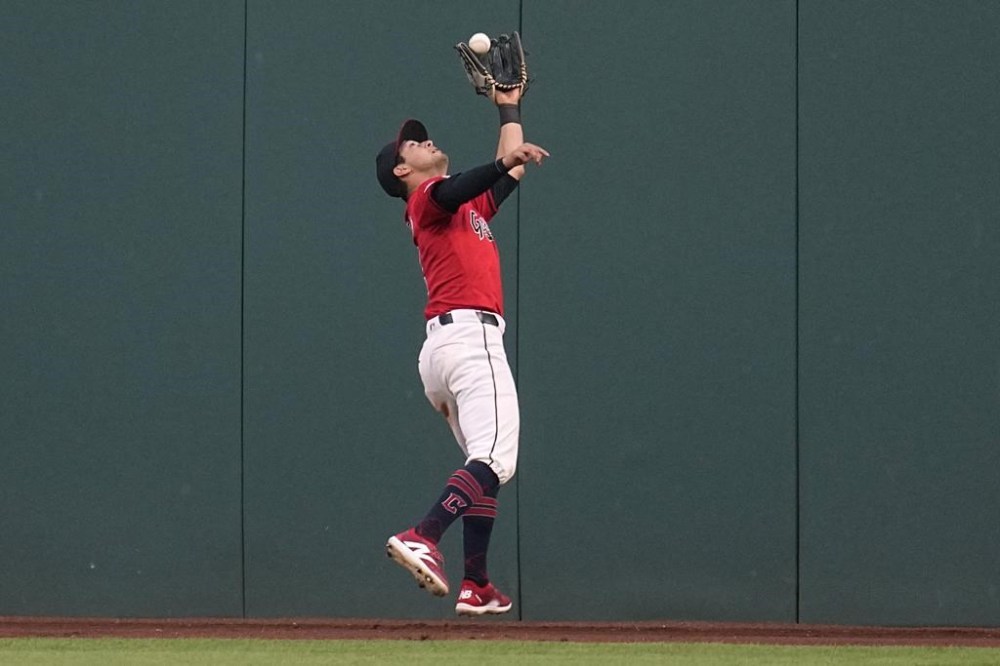 Cleveland Guardians right fielder Tyler Freeman catches a fly ball hit by New York Mets' Jeff McNeil during the eighth inning of a baseball game Tuesday, May 21, 2024, in Cleveland. (AP Photo/Sue Ogrocki)