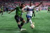 Cavalry FC's Sergio Camargo, left, and Vancouver Whitecaps' Luís Martins, right, compete for ball possession during the first half of a Canadian Championship quarterfinal soccer match, in Vancouver, on Tuesday, May 21, 2024. THE CANADIAN PRESS/Ethan Cairns