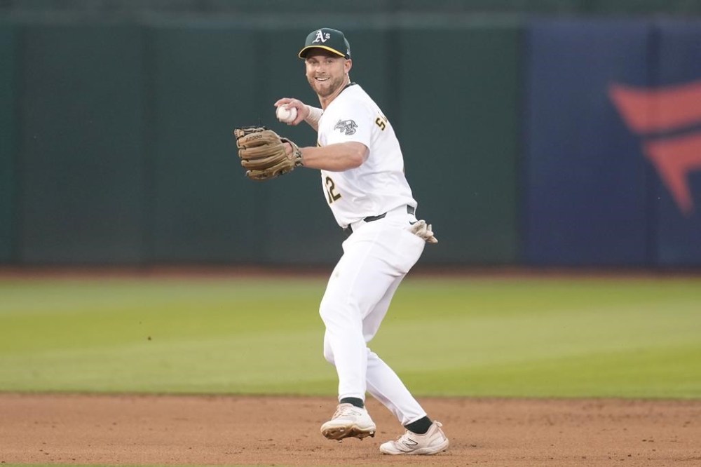 Oakland Athletics shortstop Max Schuemann throws out Colorado Rockies' Kris Bryant at first base during the sixth inning of a baseball game in Oakland, Calif., Tuesday, May 21, 2024. (AP Photo/Jeff Chiu)