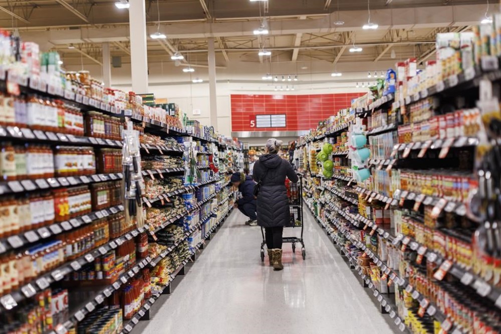 A shopper browses in an aisle at a grocery store In Toronto on Friday, Feb. 2, 2024. A new poll suggests that almost two-in-three Canadians feel that inflation at the grocery store is getting worse, even as food inflation has been steadily cooling.THE CANADIAN PRESS/Cole Burston