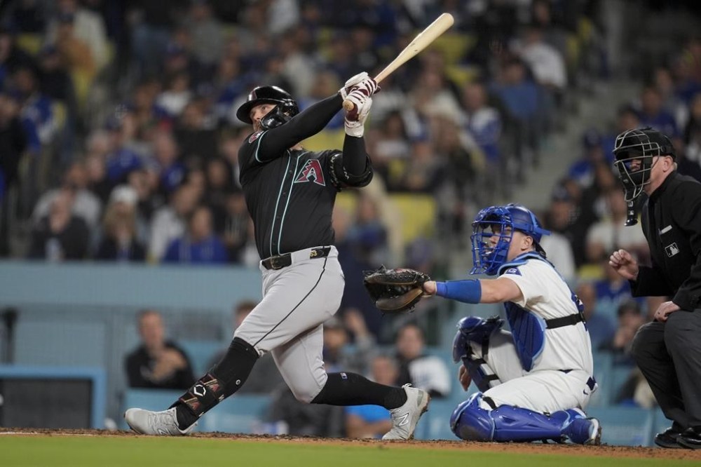 Arizona Diamondbacks' Christian Walker follows through on his solo home run during the sixth inning of a baseball game against the Los Angeles Dodgers, Tuesday, May 21, 2024, in Los Angeles. (AP Photo/Marcio Jose Sanchez)