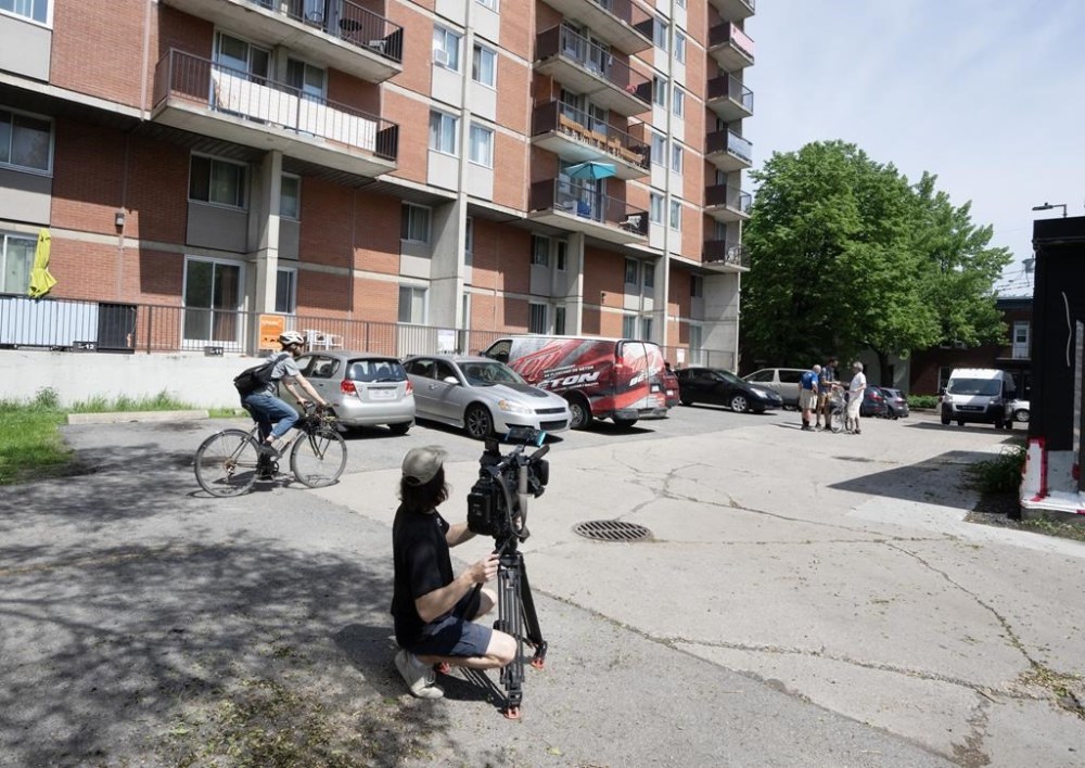 A cameraperson shoots the scene of a fight that left three people dead, Wednesday, May 22, 2024, in Montreal. City police say three young people, including a 15-year-old boy, have died after a fight broke out in an alley Tuesday night. THE CANADIAN PRESS/Ryan Remiorz