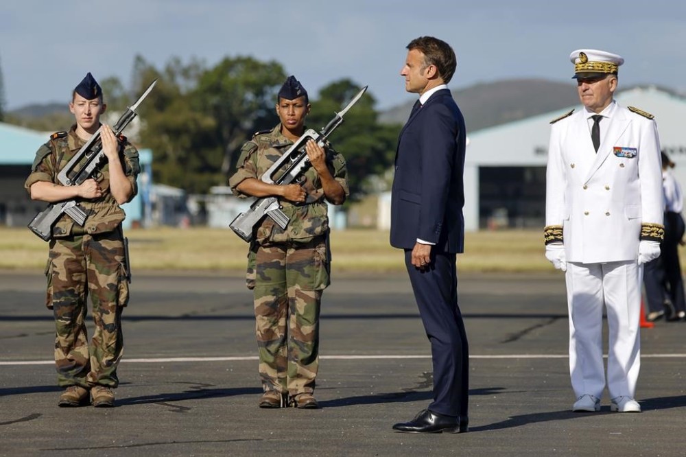 French President Emmanuel Macron stands alongside French High Commissioner to New Caledonia, Louis Le Franc, right, during the official welcome ceremony upon his arrival at Noumea ñ La Tontouta International airport, in Noumea, New Caledonia, Thursday, May 23, 2024. Macron has landed in riot-hit New Caledonia, having crossed the globe by plane from Paris in a high-profile show of support for the French Pacific archipelago wracked by deadly unrest and where indigenous people have long sought independence from France. (Ludovic Marin/Pool Photo via AP)