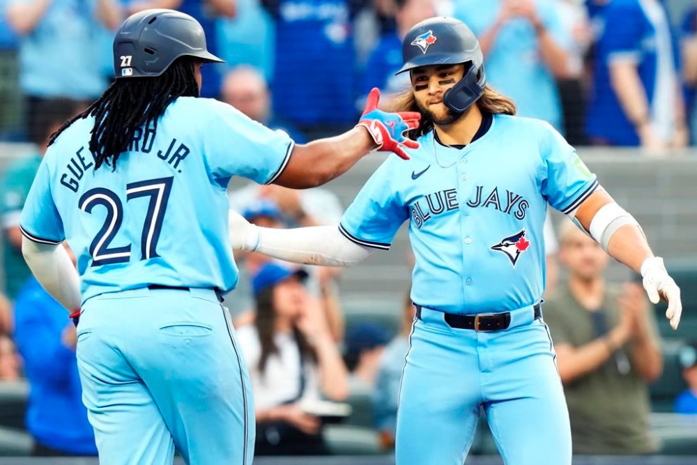 Toronto Blue Jays' Bo Bichette, right, celebrates his two-run home run against the Chicago White Sox with Vladimir Guerrero Jr. (27) during second inning MLB baseball action in Toronto on Wednesday, May 22, 2024. THE CANADIAN PRESS/Frank Gunn