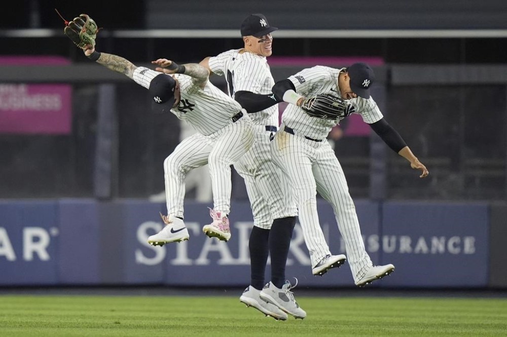 New York Yankees' Aaron Judge, center, celebrates with Juan Soto, right, and Alex Verdugo after the team's win in a baseball game against the Seattle Mariners, Wednesday, May 22, 2024, in New York. (AP Photo/Frank Franklin II)