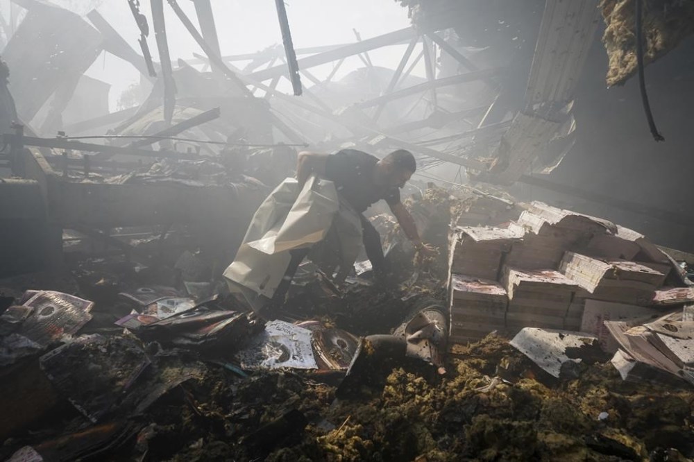 A rescuer recovers a lifeless body from under the rubble after a Russian missile hit a large printing house in Kharkiv, Ukraine, Thursday, May 23, 2024. Russian missiles slammed into Ukraine’s second-largest city in the northeast of the country and killed at least seven civilians early Thursday, officials said, as Kyiv’s army labored to hold off an intense cross-border offensive by the Kremlin’s larger and better-equipped forces. (AP Photo/Andrii Marienko)