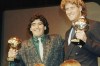 FILE - Argentina's soccer star Diego Maradona, left, and West German goalkeeper Harald Schumacher are holding their World Cup Soccer Ball awards while posing with two young soccer players during the Soccer Golden Shoe Award ceremony held in Paris, France, on Nov. 13, 1986. Diego Maradona's heirs filed a lawsuit to try to stop the auction of a trophy he was awarded after the 1986 World Cup won by Argentina. (AP Photo/Michael Lipchitz, File)
