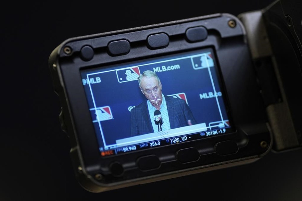 Major League Baseball commissioner Rob Manfred, displayed on a video monitor, speaks at a press conference following an owners meeting, Thursday, May 23, 2024, in New York. (AP Photo/Julia Nikhinson)