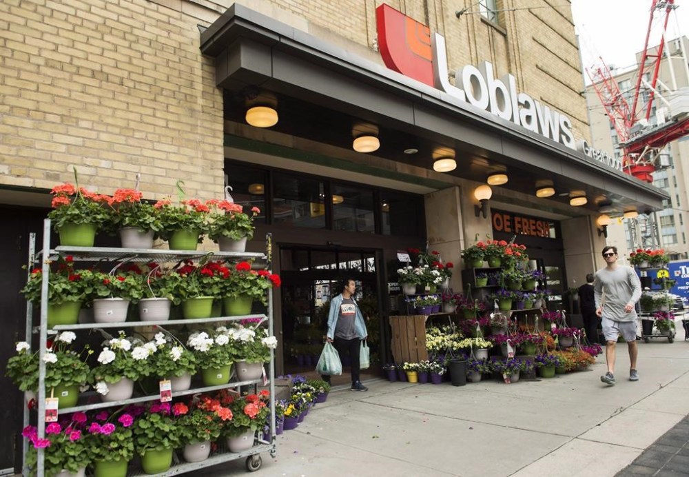 Canada's Competition Bureau has launched probes of the parents of grocery chains Loblaws and Sobeys for alleged anticompetitive conduct. A man leaves a Loblaws store in Toronto on Thursday, May 3, 2018. THE CANADIAN PRESS/Nathan Denette