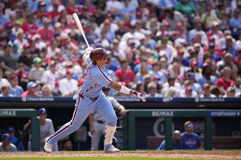 Philadelphia Phillies' Nick Castellanos follows through after hitting a home run against Texas Rangers' Jesus Tinoco during the seventh inning of a baseball game, Thursday, May 23, 2024, in Philadelphia. (AP Photo/Matt Slocum)