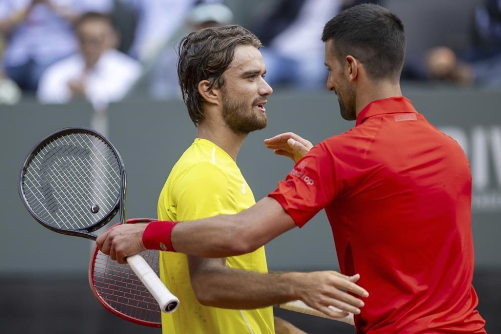 Novak Djokovic, right, of Serbia, congratulates the match winner Tomas Machac, left, of the Czech Republic, during their semi-final match, at the ATP 250 Geneva Open tennis tournament in Geneva, Switzerland, Friday, May 24, 2024. (Martial Trezzini/Keystone via AP)