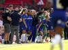 Chelsea manager Emma Hayes, centre right, and her players celebrate winning the English Women's Super League soccer match between Manchester United and Chelsea at Old Trafford, in Manchester, England, Saturday, May 18, 2024. (Martin Rickett/PA via AP)