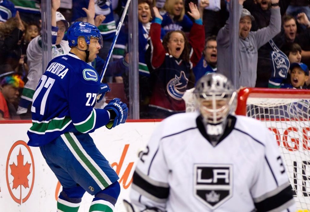 The Abbotsford Canucks have hired former NHLer Manny Malhotra as head coach of the American Hockey League team. Malhotra, left, celebrates his goal against Los Angeles Kings' Jonathan Quick, right, during first period an NHL hockey in Vancouver, B.C., Monday March 26, 2012. THE CANADIAN PRESS/Darryl Dyck