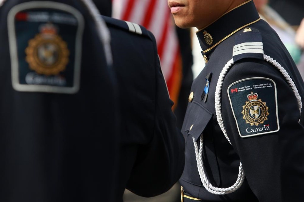 Better training and information-processing tools are needed to help the intelligence program at Canada's border agency fight everything from firearms smuggling to human trafficking, says an internal evaluation. A Canada Border Service Agency member looks on before a ceremony at the legislature in Victoria, Sunday, Sept. 24, 2023. THE CANADIAN PRESS/Chad Hipolito