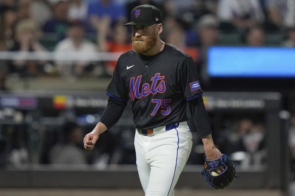 New York Mets pitcher Reed Garrett (75) walks toward the dugout in the middle of the eighth inning of the team's baseball game against the San Francisco Giants, Friday, May 24, 2024, in New York. (AP Photo/Frank Franklin II)