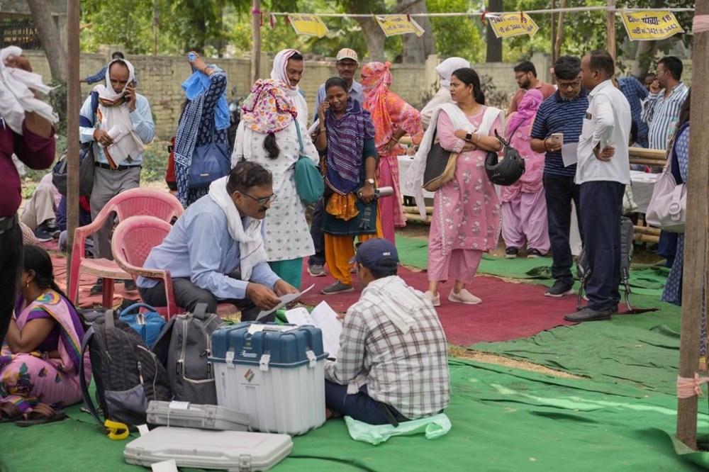 Election officials wait to proceed to their allotted polling stations on the eve of the sixth round of multi-phase national elections in Prayagraj, Uttar Pradesh, India, Friday, May 24, 2024. (AP Photo/Rajesh Kumar Singh)