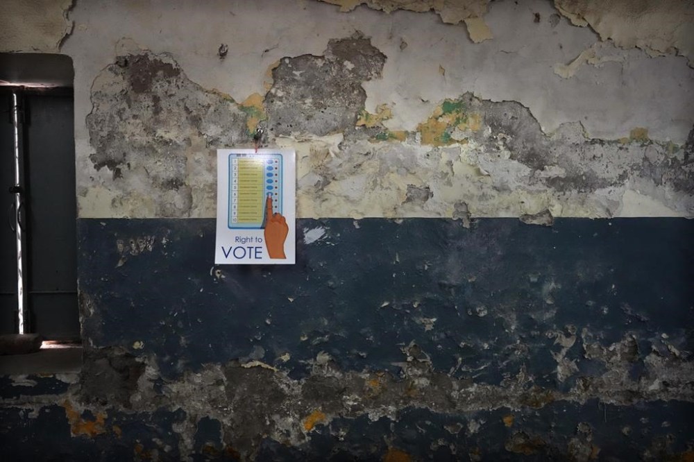 An illustration of an electronic voting machine is pasted on the wall of a school classroom turned into a polling booth on the eve of the sixth round of multi-phase national elections in New Delhi, India, Friday, May 24, 2024. (AP Photo/Manish Swarup)