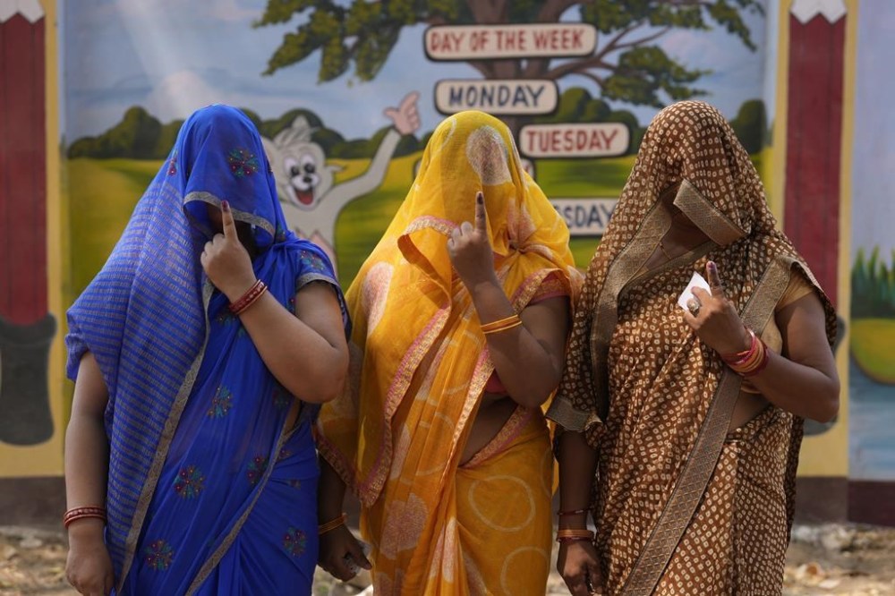 Women voters show their index fingers marked with an indelible ink after casting their vote in the sixth round of polling in India's national election in Prayagraj, India, Saturday, May 25, 2024. (AP Photo/Rajesh Kumar Singh)