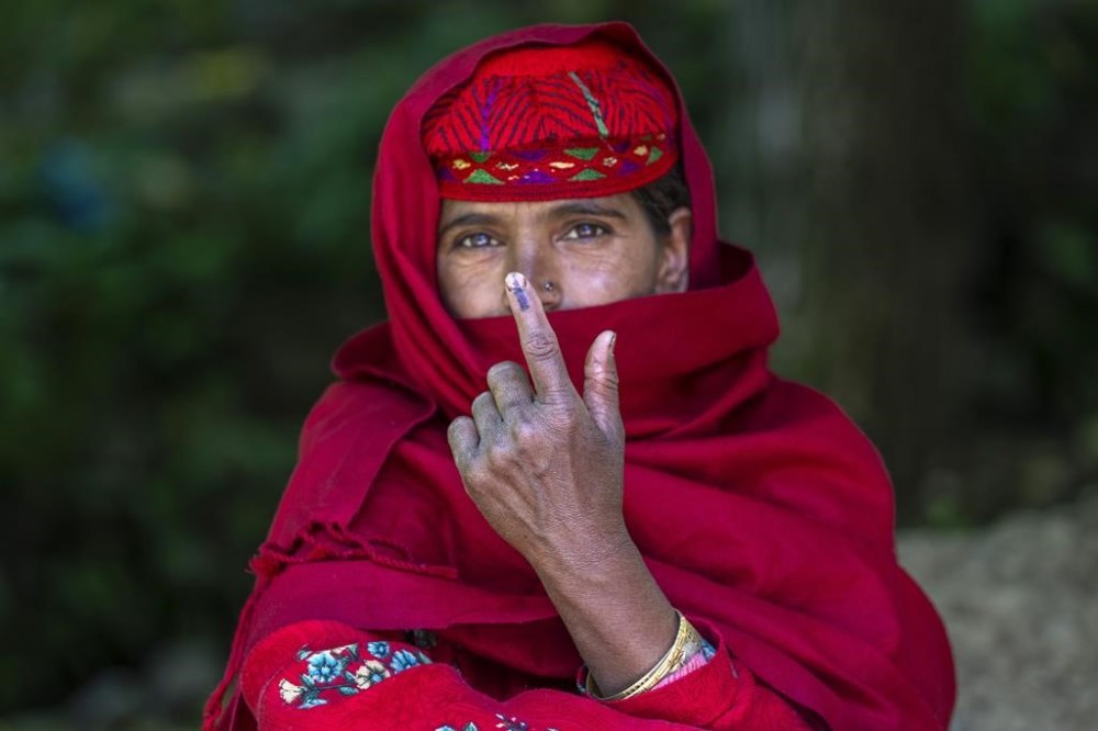 Fatima Begum shows the indelible ink mark on her index finger after casting her vote during the sixth round of polling in India's national election in Khilan Village, south of Srinagar, Indian controlled Kashmir, Saturday, May 25, 2024. (AP Photo/Dar Yasin)