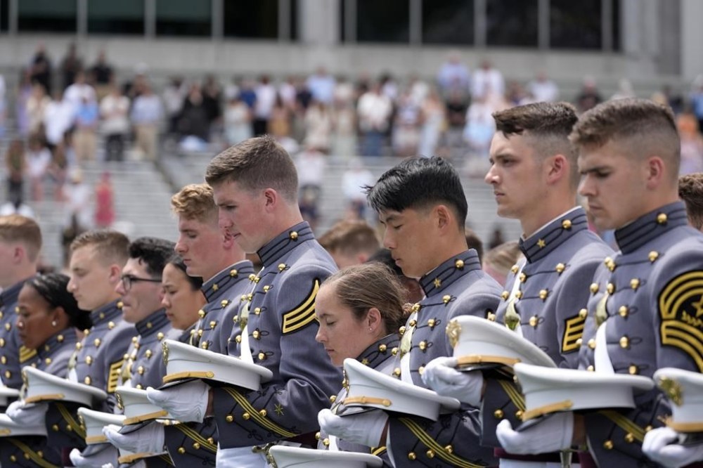 Graduating cadets bow their heads during a prayer at the U.S. Military Academy commencement ceremony, Saturday, May 25, 2024, in West Point, N.Y. (AP Photo/Alex Brandon)
