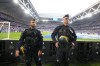 French riot police officers stand on the side of the pitch watching the crowd before the French Cup final soccer match between Lyon and PSG at the Pierre Mauroy stadium in Villeneuve d'Ascq, northern France, Saturday, May 25, 2024. (AP Photo/Michel Euler)