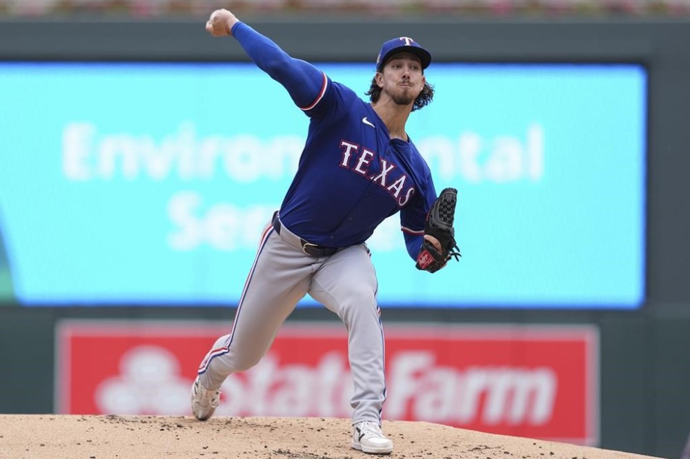 Texas Rangers starting pitcher Michael Lorenzen delivers during the first inning of a baseball game against the Minnesota Twins, Saturday, May 25, 2024, in Minneapolis. (AP Photo/Abbie Parr)