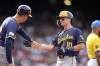 Milwaukee Brewers' Sal Frelick (10) celebrates his RBI single with first base coach Quintin Berry during the third inning of a baseball game against the Boston Red Sox, Saturday, May 25, 2024, in Boston. (AP Photo/Michael Dwyer)