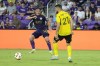 Orlando City midfielder Nicolas Lodeiro, left, passes the ball around Columbus Crew defender Yevhen Cheberko (21) during the first half of an MLS soccer match Saturday, May 25, 2024, in Orlando, Fla. (AP Photo/John Raoux)