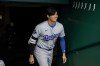 Los Angeles Dodgers' Shohei Ohtani walks into the dugout before the team's baseball game against the Cincinnati Reds on Saturday, May 25, 2024, in Cincinnati. (AP Photo/Jeff Dean)