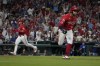 St. Louis Cardinals' Brendan Donovan, right, heads to first on a two-run single as teammate Nolan Gorman runs in to score during the eighth inning of a baseball game against the Chicago Cubs Saturday, May 25, 2024, in St. Louis. (AP Photo/Jeff Roberson)