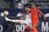 LA Galaxy defender Martín Cáceres, left, kicks while under pressure from Houston Dynamo midfielder Amine Bassi during the first half of a Major League Soccer match Saturday, May 25, 2024, in Carson, Calif. (AP Photo/Mark J. Terrill)