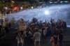 Police use water cannon to disperse demonstrators during a protest against Israeli Prime Minister Benjamin Netanyahu's government, and calling for the release of hostages held in the Gaza Strip by the Hamas militant group, in Tel Aviv, Israel, Saturday, May 25, 2024. (AP Photo/Ariel Schalit)
