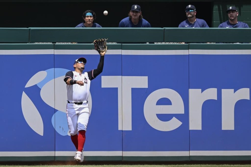 Washington Nationals left fielder Ildemaro Vargas catches a fly ball from Seattle Mariners Dylan Moore for the second out of the first inning during a baseball game, Sunday, May 26, 2024, in Washington. (AP Photo/John McDonnell)