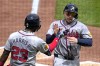 Atlanta Braves' Travis d'Arnaud, right, is greeted by Michael Harris II after scoring on a sacrifice fly by Orlando Arcia off Pittsburgh Pirates starting pitcher Martín Pérez during the fourth inning of a baseball game in Pittsburgh, Sunday, May 26, 2024. (AP Photo/Gene J. Puskar)