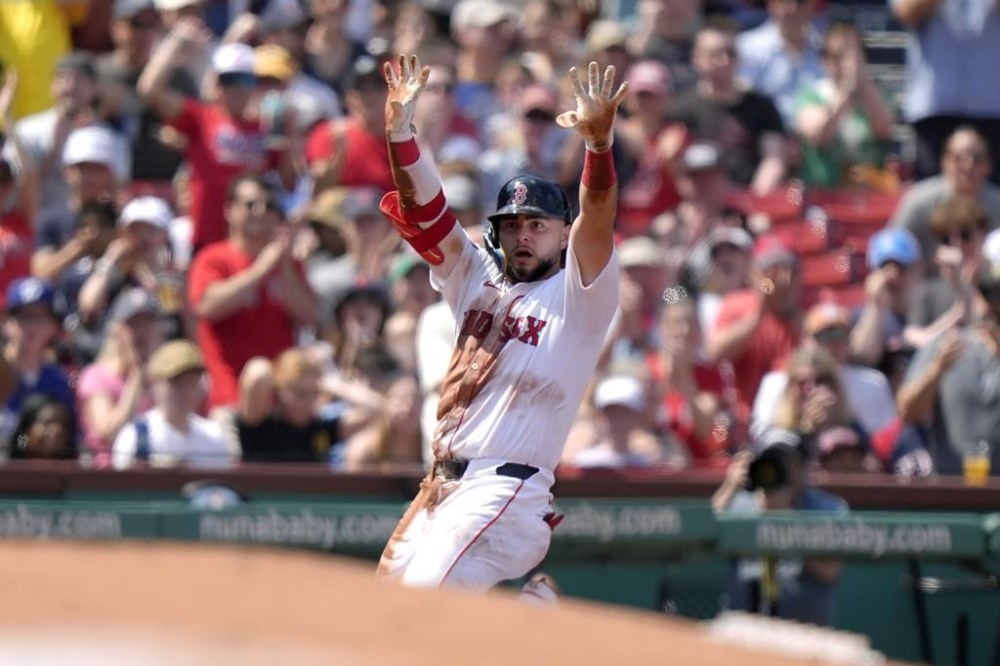 Boston Red Sox's Wilyer Abreu celebrates as he arrives at third after hitting a triple in the fourth inning of a baseball game against the Milwaukee Brewers, Sunday, May 26, 2024, in Boston. (AP Photo/Steven Senne)