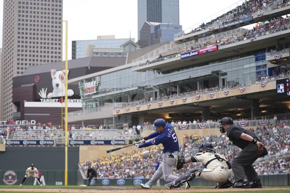 Texas Rangers' Corey Seager (5) hits a two-run home run during the third inning of a baseball game against the Minnesota Twins, Sunday, May 26, 2024, in Minneapolis. (AP Photo/Abbie Parr)