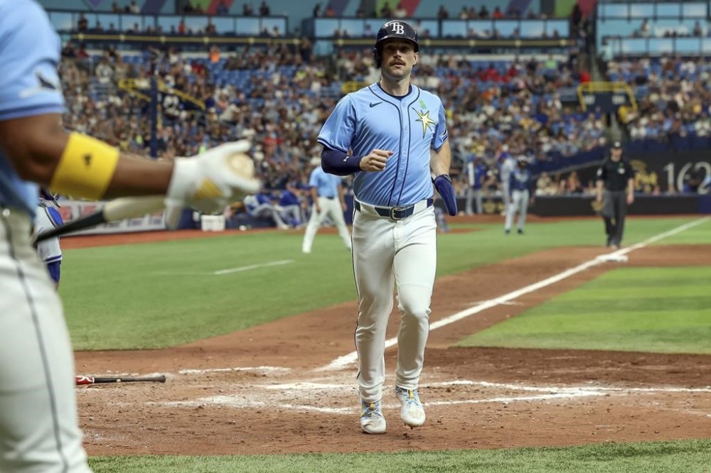Tampa Bay Rays' Brandon Lowe scores against the Kansas City Royals during the seventh inning of a baseball game, Sunday, May 26, 2024, in St. Petersburg, Fla. (AP Photo/Mike Carlson)