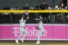 Miami Marlins center fielder Jazz Chisholm Jr., left, makes a catch in front of Marlins right fielder Dane Myers on a fly ball against Arizona Diamondbacks' Lourdes Gurriel Jr. during the first inning of a baseball game, Sunday, May 26, 2024, in Phoenix. (AP Photo/Ross D. Franklin)