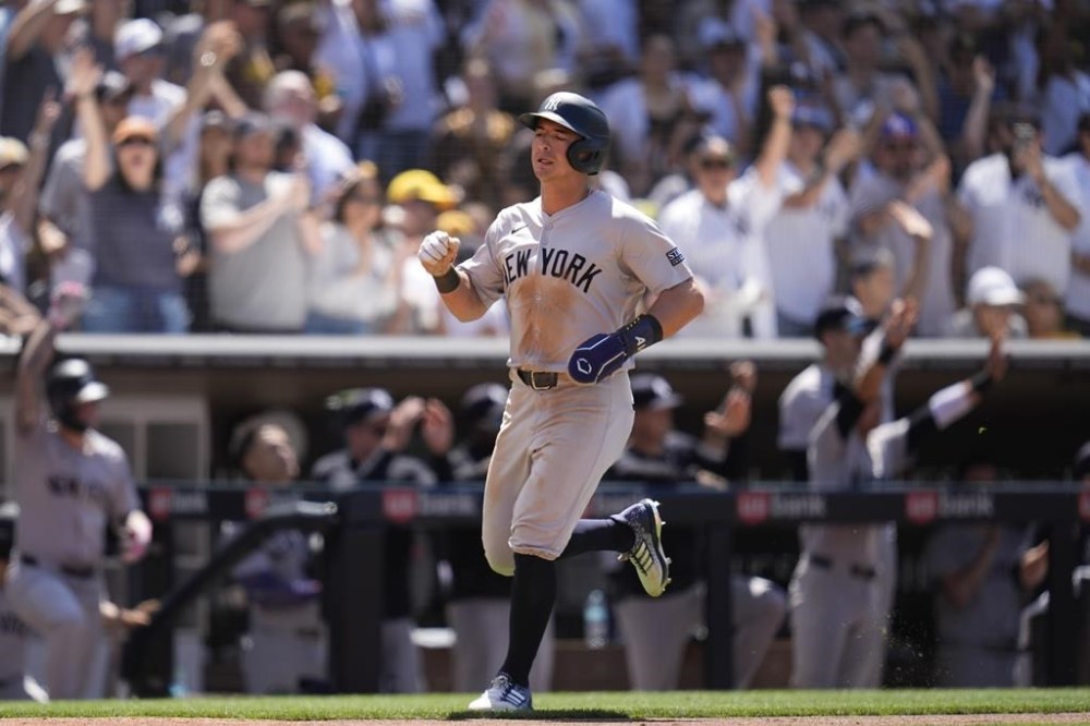 New York Yankees' Anthony Volpe scores from second base off an RBI double by Juan Soto during the sixth inning of a baseball game against the San Diego Padres, Sunday, May 26, 2024, in San Diego. (AP Photo/Gregory Bull)