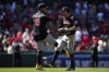 Cleveland Guardians third baseman Gabriel Arias (13) and center fielder Tyler Freeman celebrate after a 5-4 win over the Los Angeles Angels in a baseball game in Anaheim, Calif., Sunday, May 26, 2024. (AP Photo/Ashley Landis)