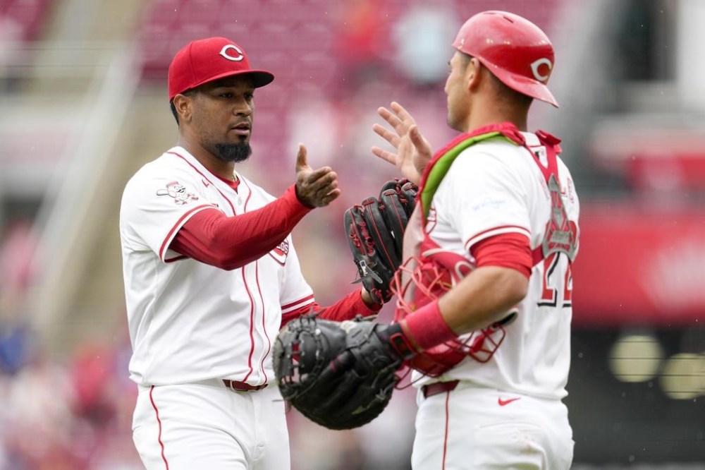 Cincinnati Reds' Alexis Díaz, left, celebrates with teammate Luke Maile after the Reds defeated the Los Angeles Dodgers in a baseball game Sunday, May 26, 2024, in Cincinnati. (AP Photo/Jeff Dean)