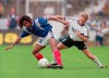 FILE - Christian Karembeu of France, left, protects the ball during the international soccer match between Germany and France at Stuttgart, Germany, Saturday, June 1, 1996. Former international soccer player Christian Karembeu, a 1998 World Cup and Euro 2000 winner with France, says two of his relatives have been killed during the unrest in the French Pacific territory of New Caledonia that has left seven people dead. (AP Photo/Thomas Kienzle, File)