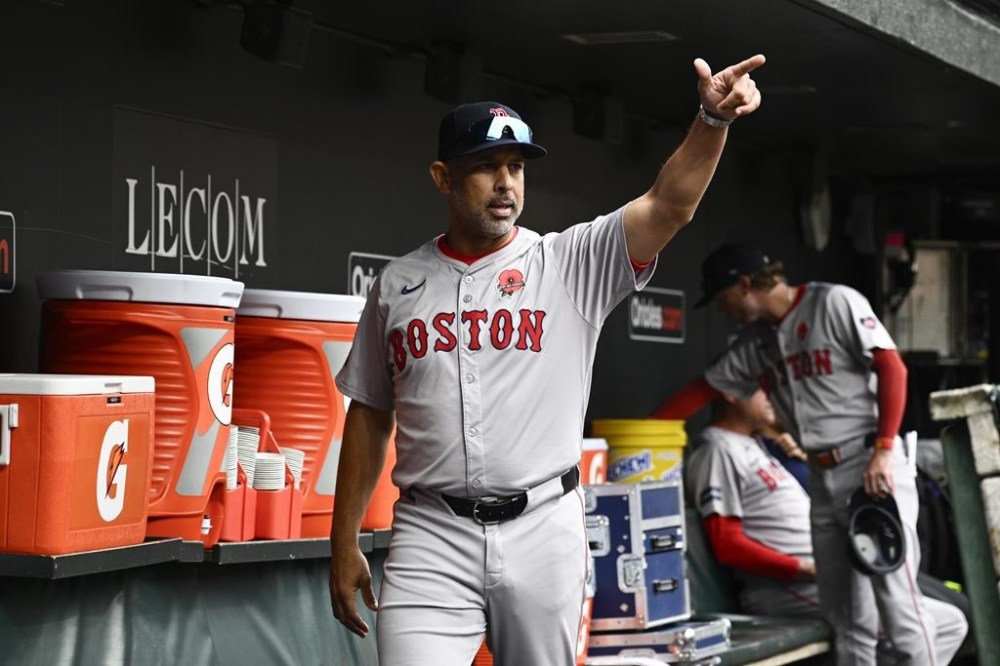 Boston Red Sox manager Alex Cora gestures from the dugout before a baseball game against the Baltimore Orioles, Monday, May 27, 2024, in Baltimore. (AP Photo/Nick Wass)