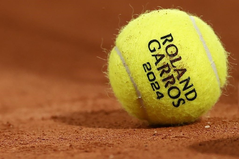 A ball lies on the clay court during the first round match between Poland's Iga Swiatek and France's Leolia Jeanjean at the French Open tennis tournament at the Roland Garros stadium in Paris, Monday, May 27, 2024. (AP Photo/Jean-Francois Badias)
