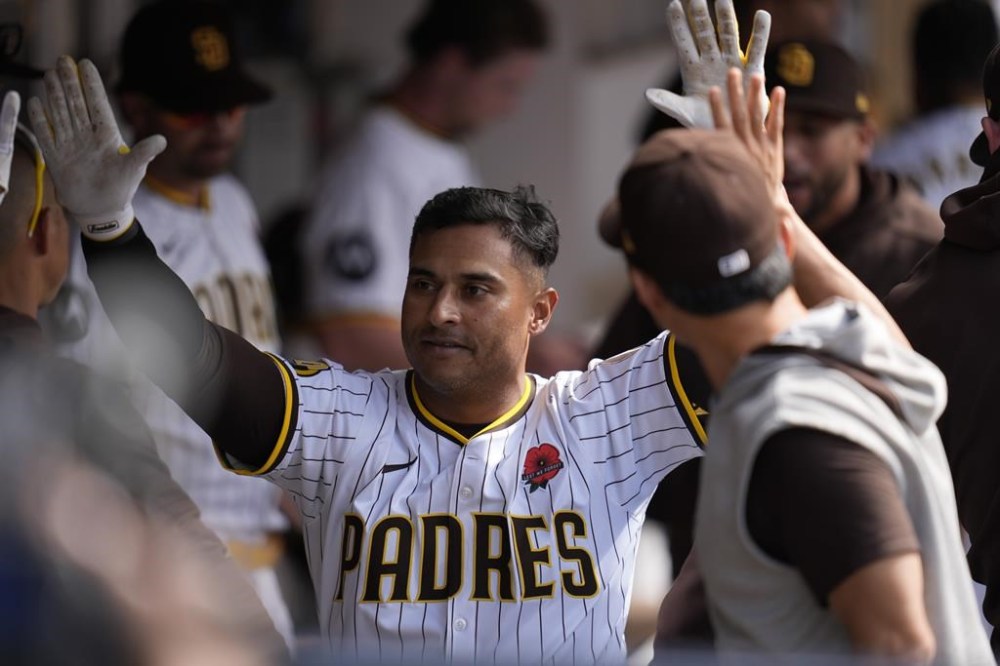 San Diego Padres' Donovan Solano celebrates with teammates in the dugout after hitting a home run during the second inning of a baseball game against the Miami Marlins Monday, May 27, 2024, in San Diego. (AP Photo/Gregory Bull)