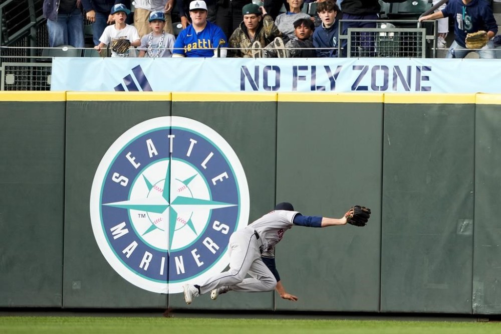 Houston Astros center fielder Jake Meyers makes a diving catch of an RBI sacrifice fly by Seattle Mariners' Cal Raleigh during the first inning of a baseball game Monday, May 27, 2024, in Seattle. (AP Photo/Lindsey Wasson)